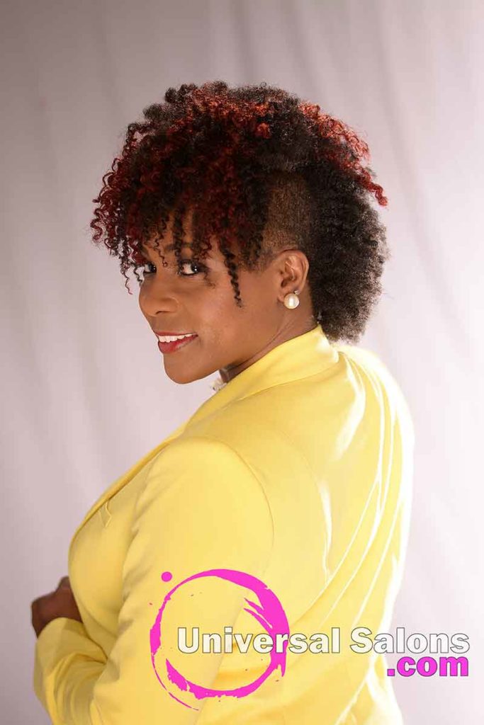 The Left Side View of a Curly Mohawk hairstyle for black Women from Nivi Grimball